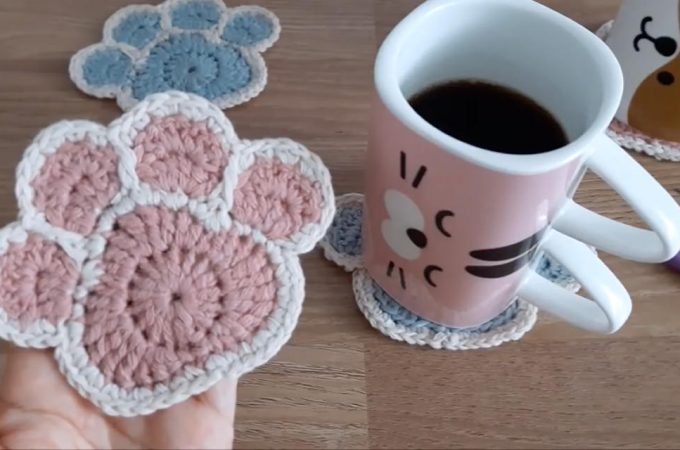 Crochet Paw Coaster Featured Image - Learn to crochet this unique coaster that is in the shape of a cute animal paw! Watch the video tutorial to learn making this adorable crochet paw coaster.
