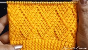 Knit Barfi Stitch Featured Image - This knit Barfi stitch pattern is both a beautiful rhombus stitch that makes a lovely square! There are unlimited knitting projects that you can make with this stitch.