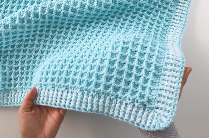 Crochet Waffle Stitch Blanket Featured - This free video tutorial covers how to create an adorable crochet waffle stitch blanket. Crocheting a baby blanket is so much fun and easy for beginners to make!