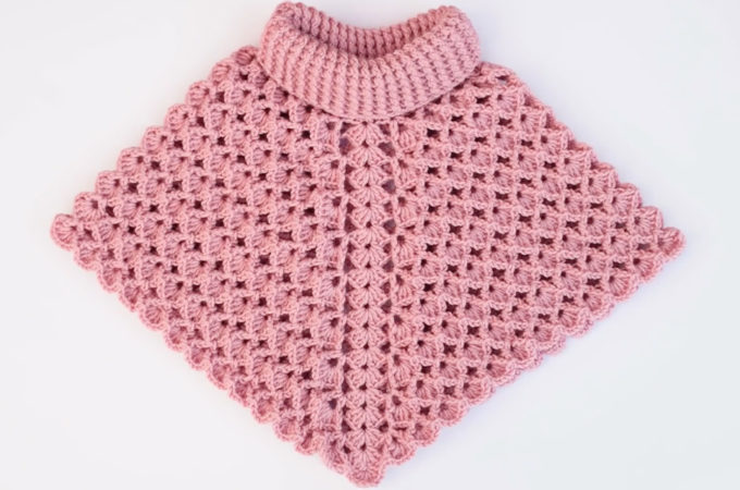 Crochet Baby Poncho Featured Image - Make this beautiful crochet baby poncho for any special child in your life. Watch this free video tutorial to learn how to make this beautiful crochet baby poncho.