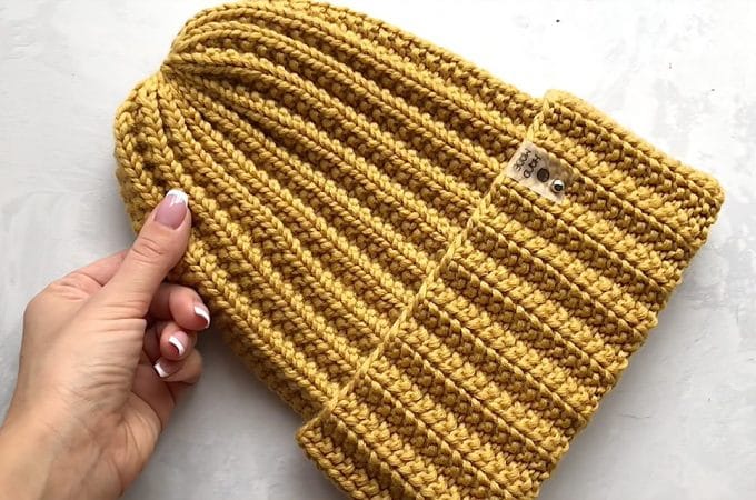 Knitting Beanie Tutorial Featured - This knitting beanie tutorial covers how to create a beautiful beanie for different age groups. Knitted beanies are so much fun to make and easy for beginners to stitch!