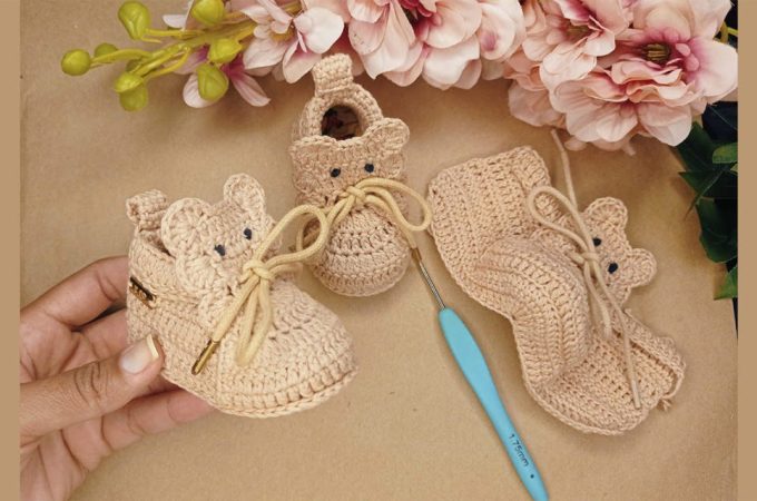 Crochet Newborn Booties Featured - Dive into the delightful world of crochet newborn booties, where artistry meets practicality in the tiniest of packages.