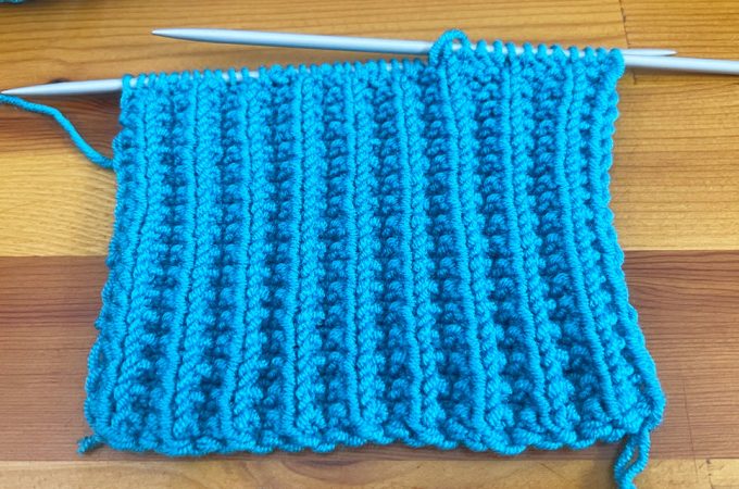 Cartridge Belt Rib Stitch Featured - Learn making the cartridge belt rib stitch that is a classic stitch pattern that combines simplicity with a strikingly textured appearance.