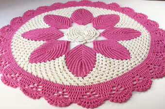 Crochet Daisy Rug Featured - A crochet daisy rug is more than just a floor covering—it's a charming statement piece that brings warmth, elegance, and a touch of nature into any space.