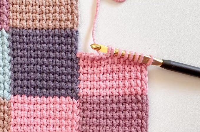Crochet Tunisian Simple Stitch Featured - The Crochet Tunisian Simple Stitch is a gateway to a whole new dimension of crochet. This unique technique, often referred to as a blend between knitting and crochet, creates a beautifully textured fabric with a distinctive woven look.