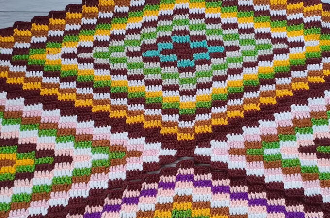 Crochet Area Rug Featured - A crochet area rug isn't just a floor covering—it's a conversation starter, a cozy statement, and a stunning way to personalize any space.